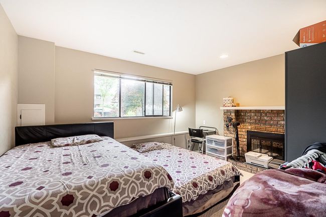 Bedroom featuring a brick fireplace | Image 26