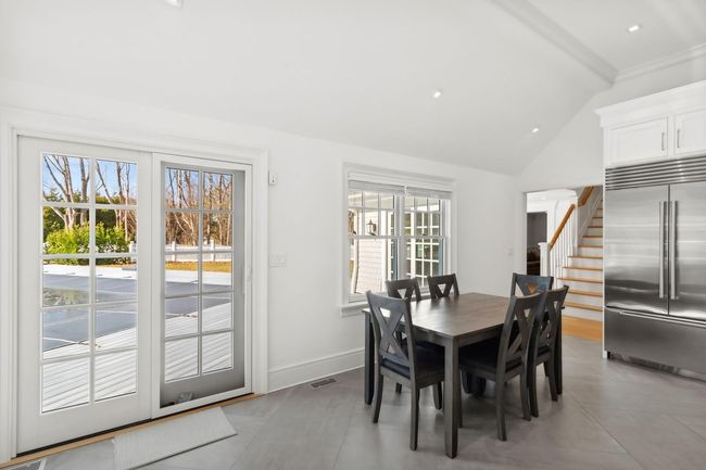 Dining room with lofted ceiling with beams | Image 28