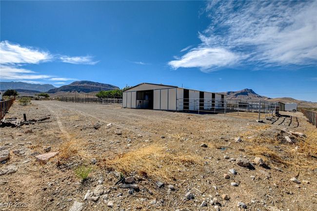 View of pole building featuring a mountain view and an exterior structure | Image 45