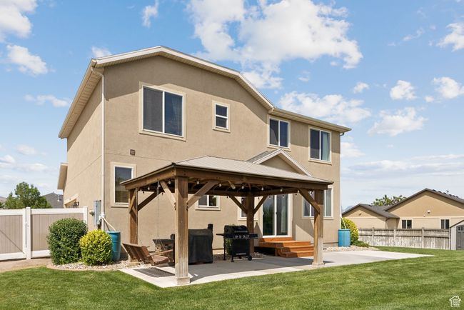 Rear view of property with a gazebo, stucco siding, a patio area, and a gate | Image 42