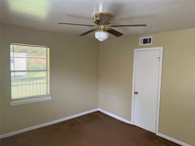 Spare room featuring dark colored carpet and a ceiling fan | Image 17