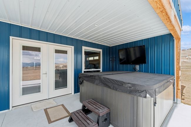 View of patio with french doors and a hot tub | Image 25
