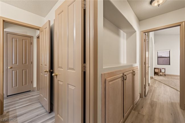 Hallway featuring light wood-type flooring and a textured ceiling | Image 23