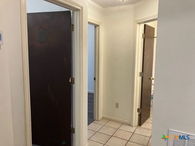 Hallway leading to extra bedrooms | Image 10