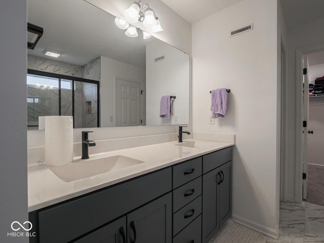 full bath featuring a sink, visible vents, marble finish floor, and a stall shower | Image 38