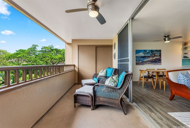 The lanai is wide enough for furniture to sit outside and relax from a long day. A large storage closet is featured at the end. | Image 7