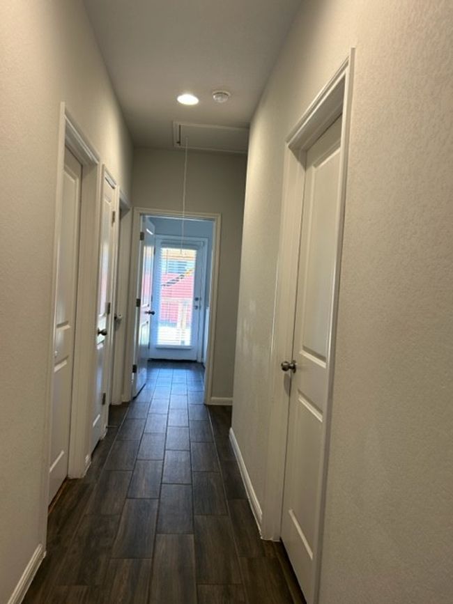 Hallway with baseboards, dark wood finished floors, and attic access | Image 7
