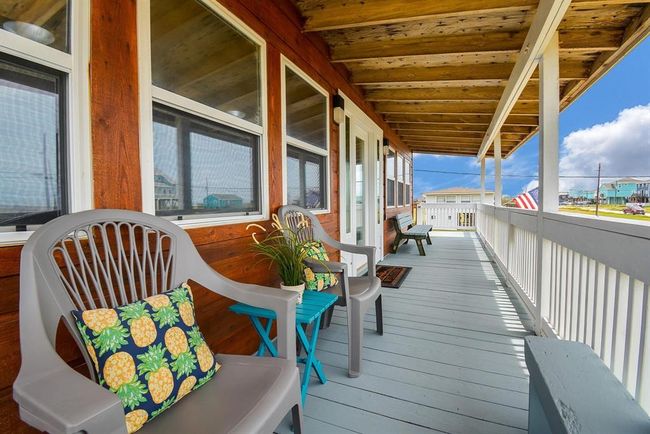This photo showcases the charming, covered, beach facing deck for relaxing while watching the Gulf of America and enjoying the outdoors. | Image 18
