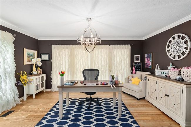 Office with ornamental molding, a chandelier, and light wood-type flooring | Image 9