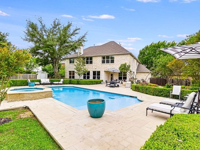 View of pool with an in ground hot tub, a fenced in pool, a storage shed, a fenced backyard, and a patio | Image 25