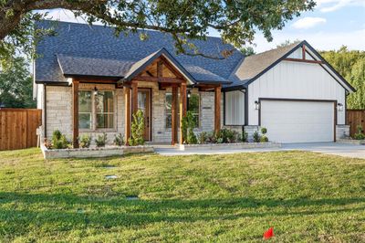 View of front facade featuring a garage and a front yard | Image 1