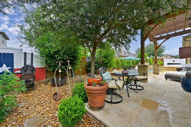 Fenced backyard featuring a pergola, a patio area, and outdoor dining space | Image 26