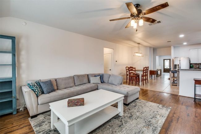 Living area featuring ceiling fan, dark wood-style flooring, and recessed lighting | Image 6