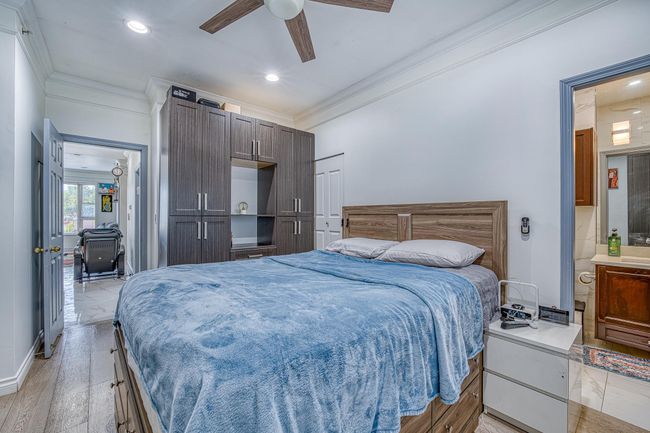 Bedroom with crown molding, recessed lighting, ceiling fan, and light wood-style floors | Image 17
