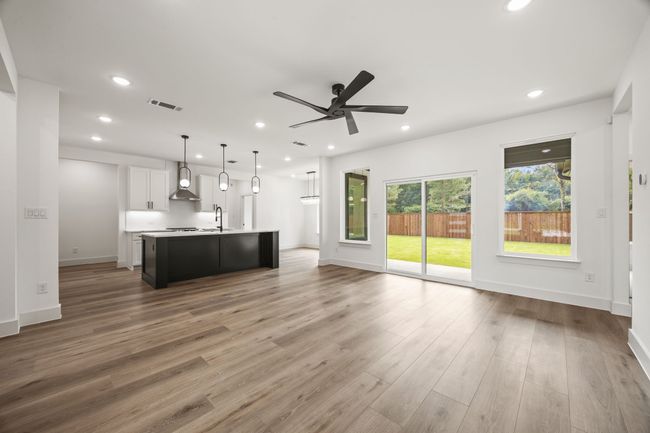 Unfurnished living room featuring a sink, recessed lighting, a ceiling fan, light wood finished floors, and baseboards | Image 8