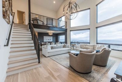 Living room with light hardwood / wood-style flooring, a mountain view, an inviting chandelier, and a high ceiling | Image 3