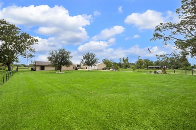 The list of updates inside and out are long including fresh interior and exterior paint, new lifetime gutters with gutter guards, AC unit replaced in 2022, new landscaping, new back concrete patio, new flooring throughout, exterior screen doors, new decorative stamped concrete back patio and much more! | Image 12