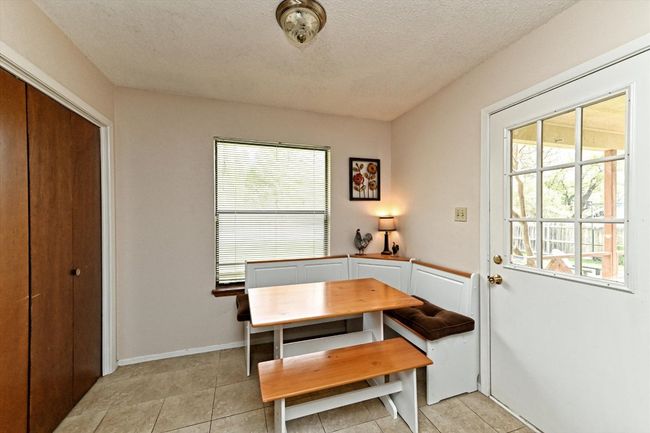 Breakfast area space with windows and exterior door plus textured ceiling | Image 12