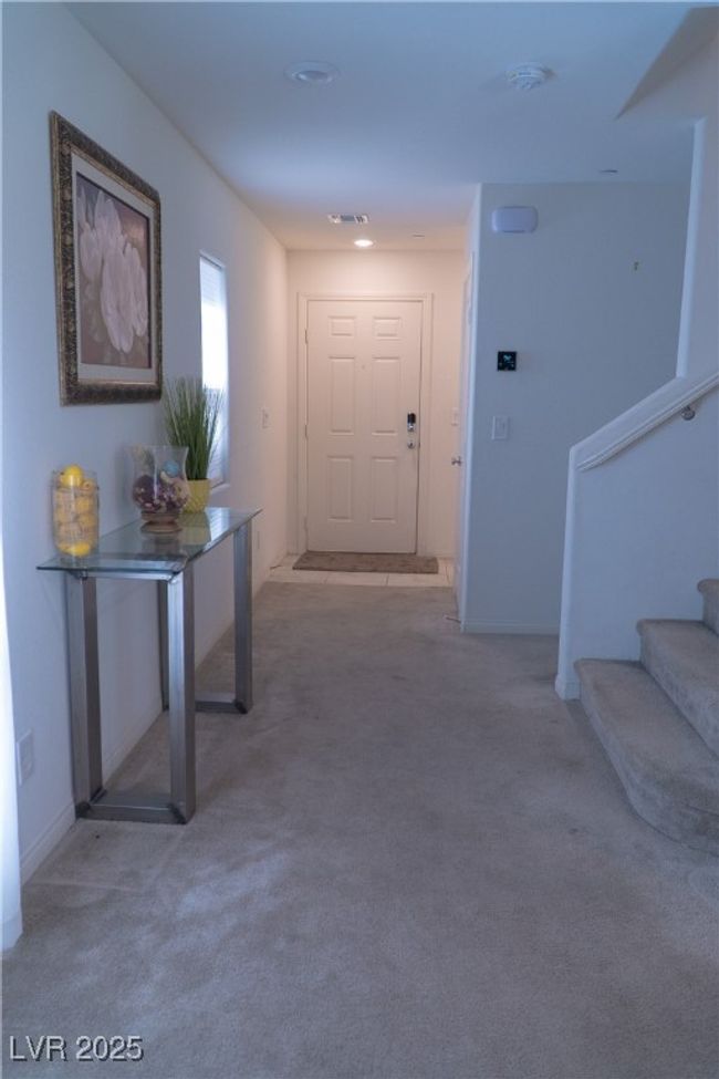 Hallway featuring baseboards, carpet floors, visible vents, and stairs | Image 10