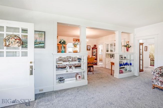 living area at front covered porch entrance looking into formal dining area. | Image 4
