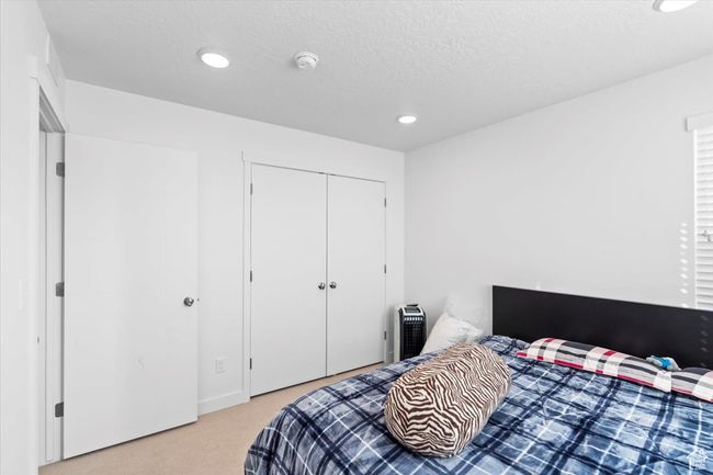 Bedroom featuring recessed lighting, a closet, and light colored carpet | Image 22