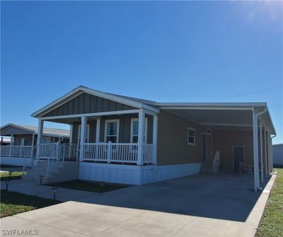 Extra-wide carport with a spacious storage and workroom. This is a people-friendly, pet-friendly community. | Image 2