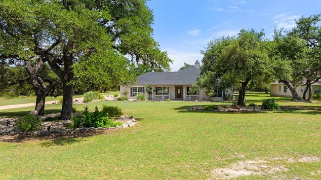 The majestic trees are situated in both front and back of home. | Image 39