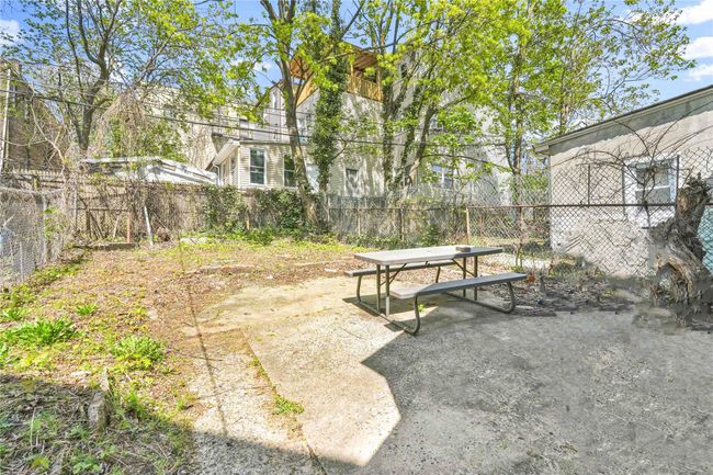 View of yard with a fenced backyard, outdoor dining area, and a patio area | Image 15