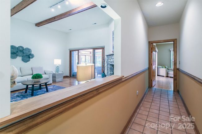 Hall to primary bedroom with a little peak into the living area | Image 34