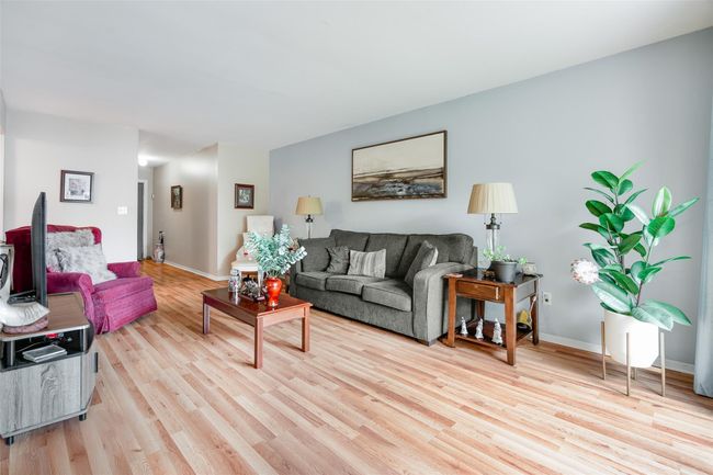 Living area featuring light wood finished floors and baseboards | Image 4