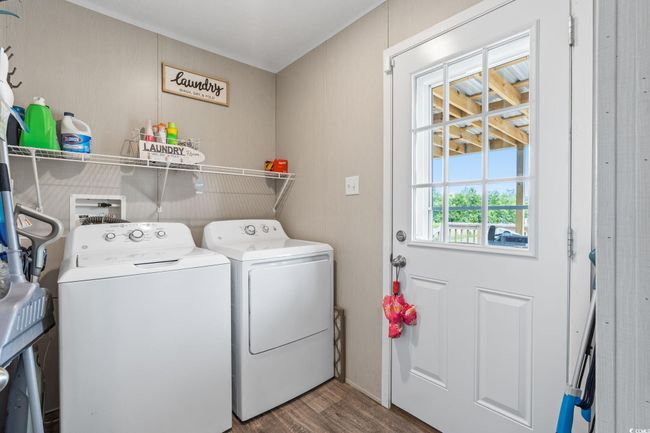 Laundry area featuring separate washer and dryer and wood finished floors | Image 27