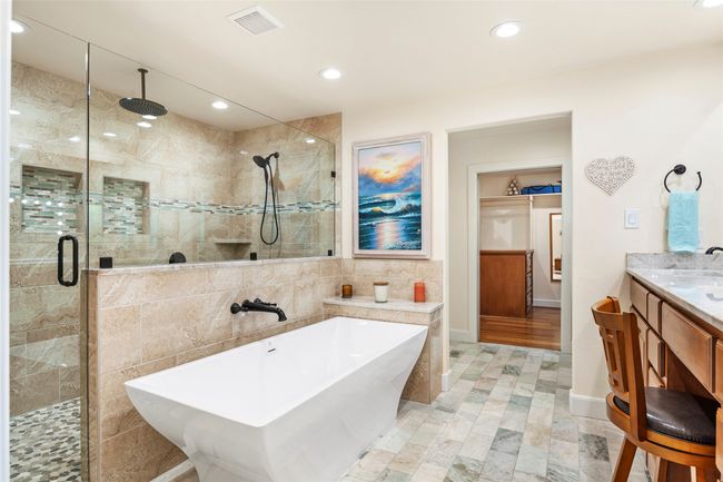 Check out that gorgeous shower with multiple shower heads and a Hollywood tub perfect for relaxing | Image 25
