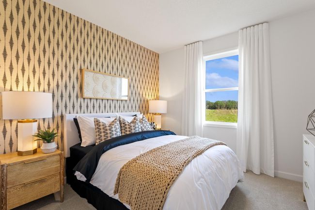 (Photo of a decorated model, actual homes finishes will vary) The main level bed. | Image 10