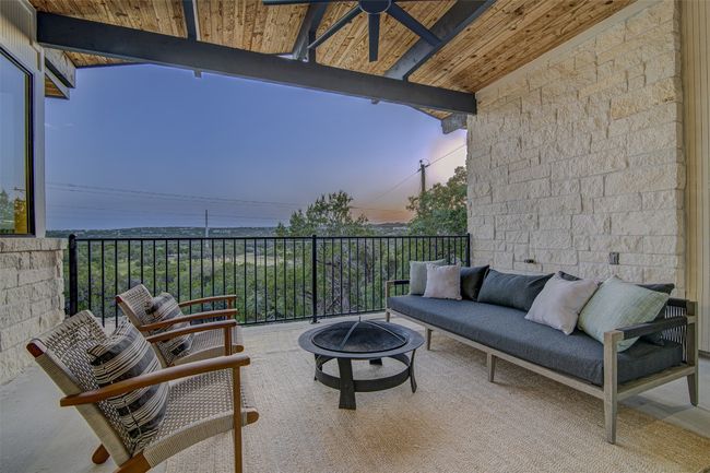 Patio terrace at dusk with an outdoor living space with a fire pit | Image 9
