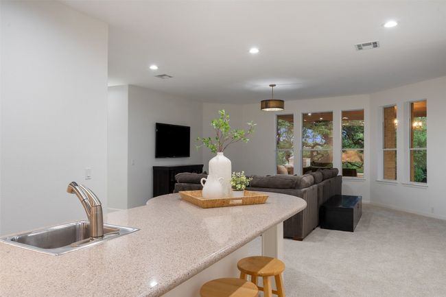 Kitchen with a sink, visible vents, recessed lighting, and light carpet | Image 24