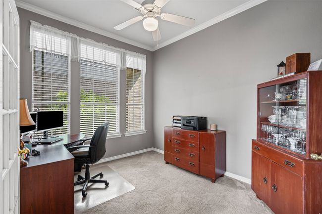 Home office featuring light carpet, ornamental molding, plenty of natural light, baseboards, and a ceiling fan | Image 19