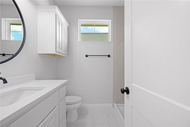 Bathroom featuring toilet, walk in shower, and vanity | Image 22