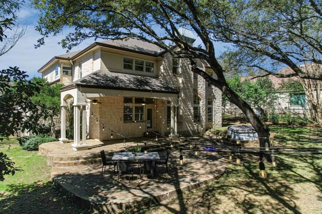 Rear view of house featuring a patio area, ceiling fan, and stucco siding. | Image 38
