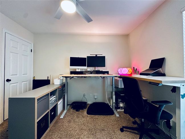 Carpeted office space with a ceiling fan | Image 15