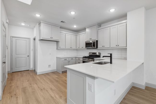 The kitchen peninsula does double duty as the perfect place for a quick family meal or homework station! REPRESENTATIVE PHOTO | Image 6