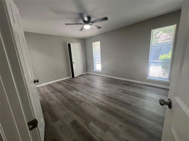 Unfurnished room featuring ceiling fan and dark wood-type flooring | Image 12