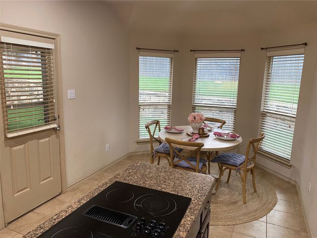 Dining room with baseboards, a healthy amount of sunlight, and light tile patterned floors | Image 16