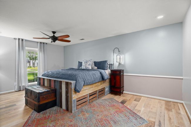 This primary bedroom is spacious and bright, featuring a large window for lots of natural lighting. | Image 23