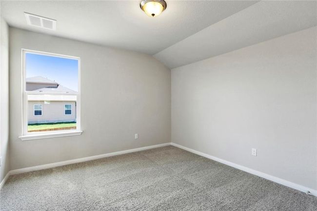 Carpeted empty room featuring baseboards and lofted ceiling | Image 20