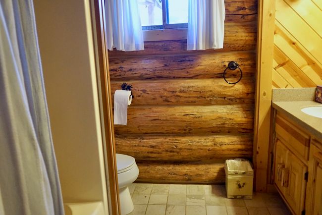 Bathroom with toilet, log walls, and vanity | Image 34