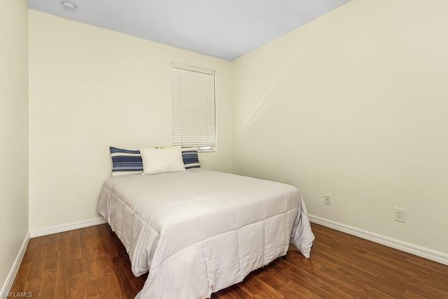 Bedroom featuring baseboards and wood finished floors | Image 19