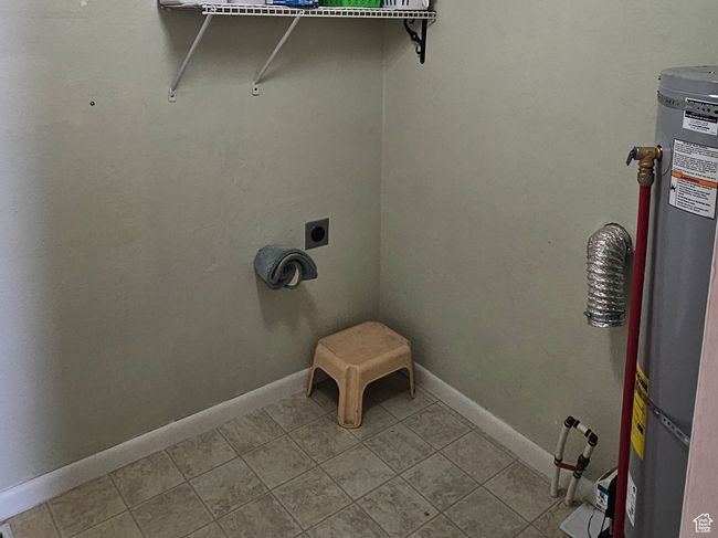 Washroom with a textured ceiling and water heater | Image 36