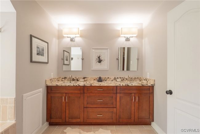 Full bathroom with tile patterned floors, double vanity, baseboards, and a sink | Image 33