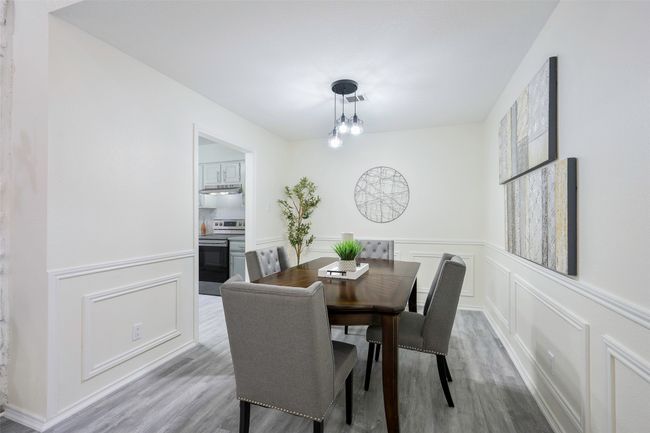 Dining room featuring a decorative wall, wood finished floors, and visible vents | Image 8