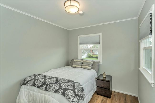 Bedroom with baseboards, ornamental molding, and wood finished floors | Image 22